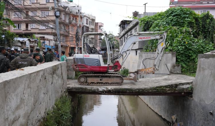 मनमती खोलामाथि बनेका अनधिकृत संरचनामाथि काठमाडौं महानगरको डोजर